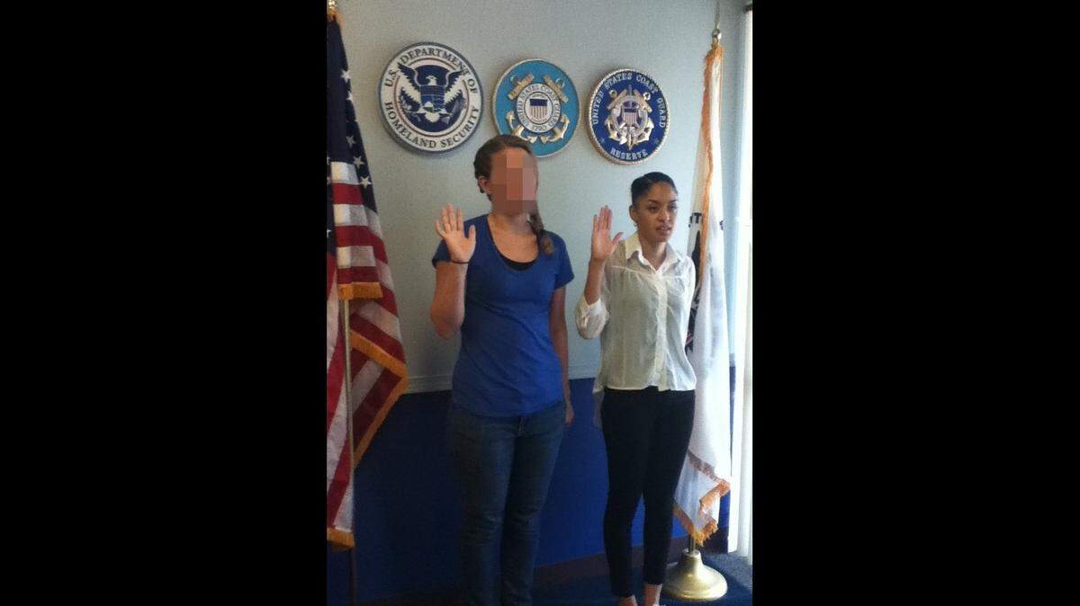 This photo shows Monique Garbutt, on the right, being sworn into the Coast Guard in 2013 in Colorado. She exited six years later after an assault and what she feels was retaliation for demanding answers.