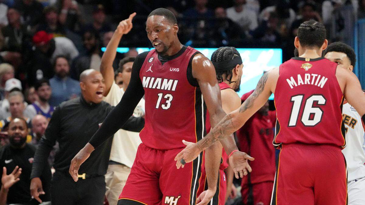 Miami Heat center Bam Adebayo (13) high fives forward Caleb Martin (16) after a play against the Denver Nuggets during the first quarter in game five of the 2023 NBA Finals at Ball Arena.