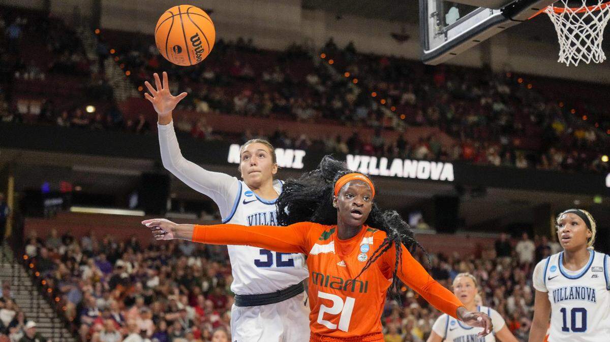 Mar 24, 2023; Greenville, SC, USA; Villanova Wildcats guard Bella Runyan (32) tries for the loose ball with Miami Hurricanes forward Lola Pendande (21) during the second half of the NCAA Women’s Tournament at Bon Secours Wellness Arena. Mandatory Credit: Jim Dedmon-USA TODAY Sports