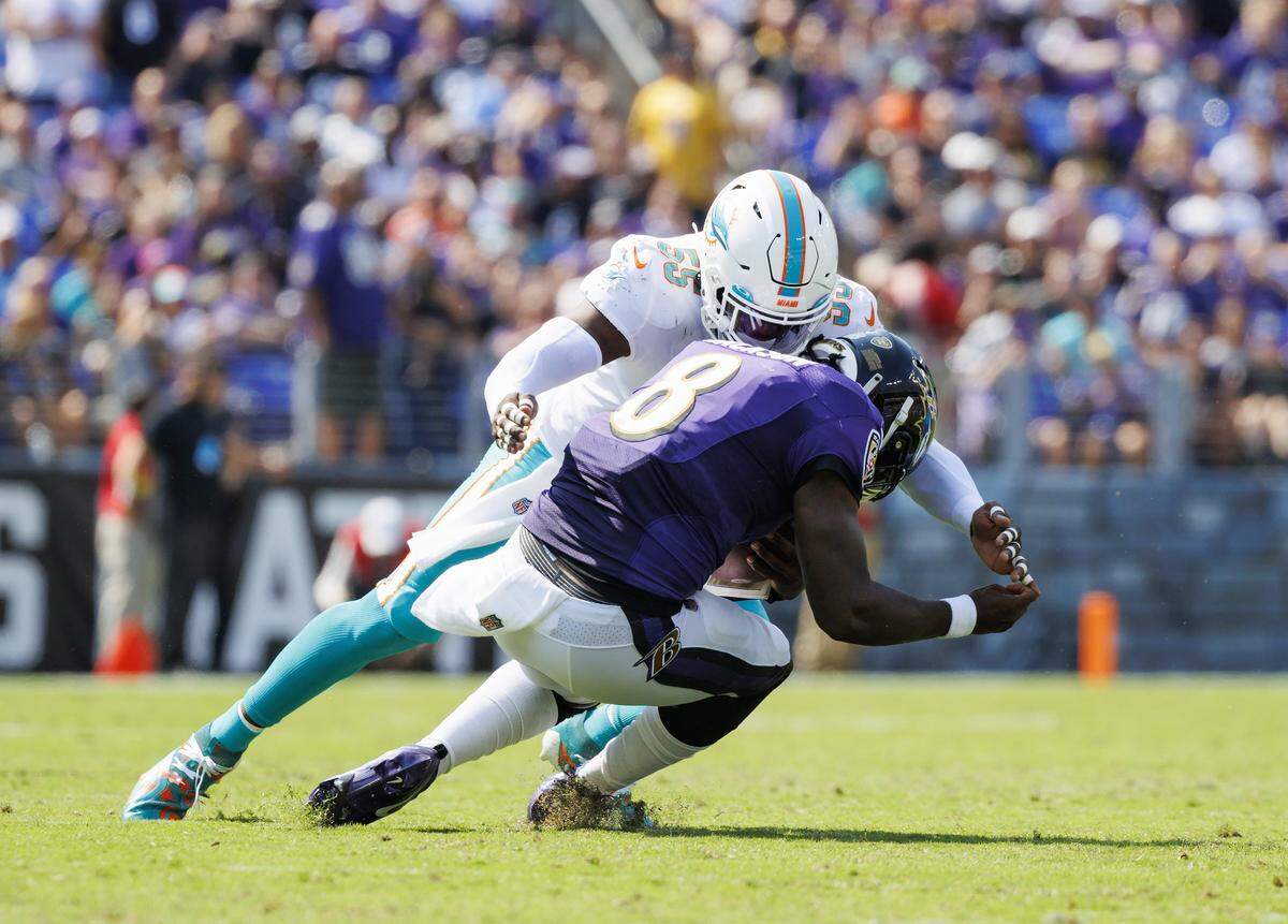 Baltimore Ravens quarterback Lamar Jackson (8) is sacked  by Miami Dolphins linebacker Jerome Baker (55) during second quarter of an NFL football game at M&T Bank Stadium on Sunday, September 18, 2022 in Baltimore, MD.