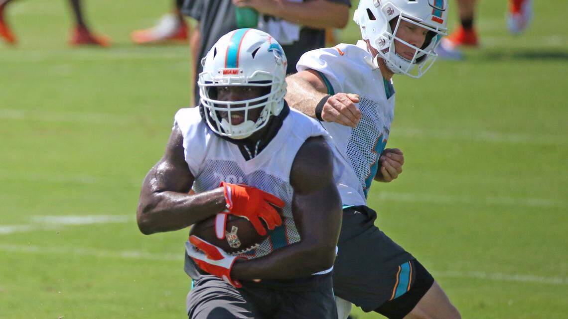 Miami Dolphins quarterback Ryan Tannehill #17 handoff to Dolphins running back Frank Gore #21 during the Miami Dolphins Organized Team Activities at the Baptist Health Training Facility at Nova Southeastern University on Wednesday, June 6, 2018 in Davie.