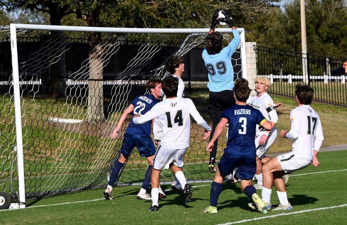 Westminster Christian goalkeeper Connor Benitez leaps in the air to save a shot by Melbourne Holy Trinity Episcopal during a Class 2A boys state soccer semifinal on Tuesday at Lake Myrtle Sports Complex in Auburndale.