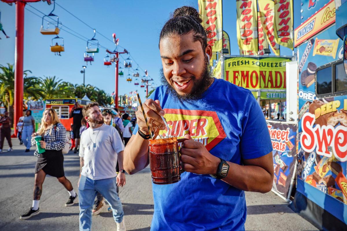 Allan Elliott tries out a deep-fried milkshake during the opening day of the Miami-Dade County Fair & Exposition.