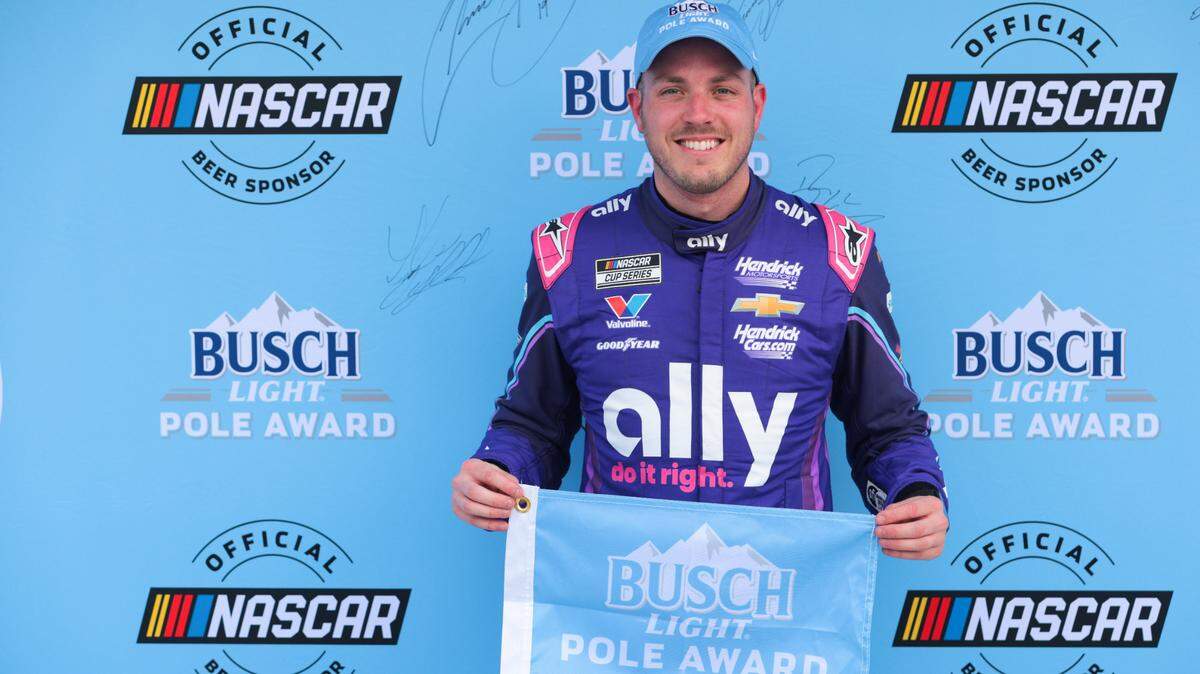 Mar 22, 2025; Homestead, Florida, USA; NASCAR Cup Series driver Alex Bowman (48) celebrates with Busch Light Pole Award after winning the pole for the the Straight Talk Wireless 400 at Homestead-Miami Speedway. Mandatory Credit: Sam Navarro-Imagn Images