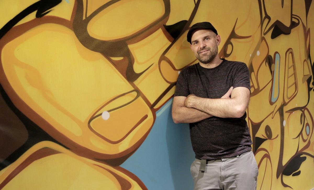 Miami, Florida, March 27, 2018 - Artist Daniel “Krave” Fila poses in front of a finished section of his mural on the 22nd floor. Canvas, a new condo development in downtown, has hired local street artists to paint the interior hallways of the building, creating a unique aesthetic and giving work to local artists.
