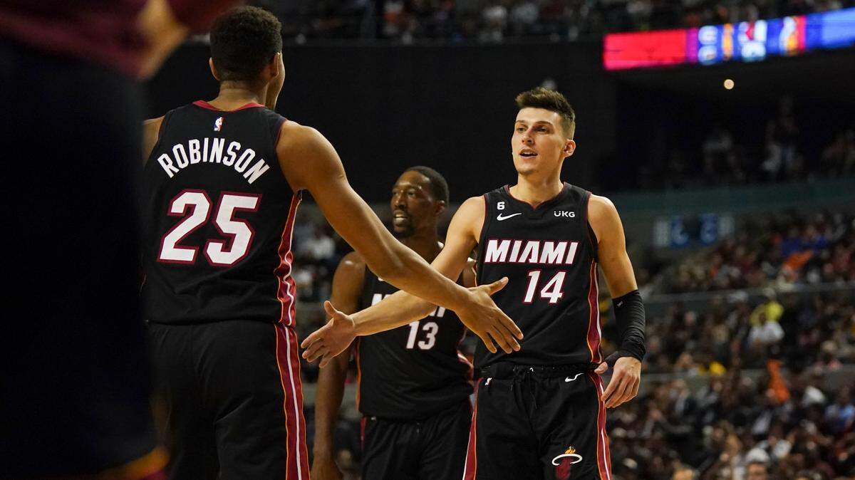 Miami Heat’s Tyler Herro, right, slap hands with Orlando Robinson during the second half of an NBA basketball game against San Antonio Spurs, at the Mexico Arena in Mexico City, Saturday, Dec. 17, 2022.