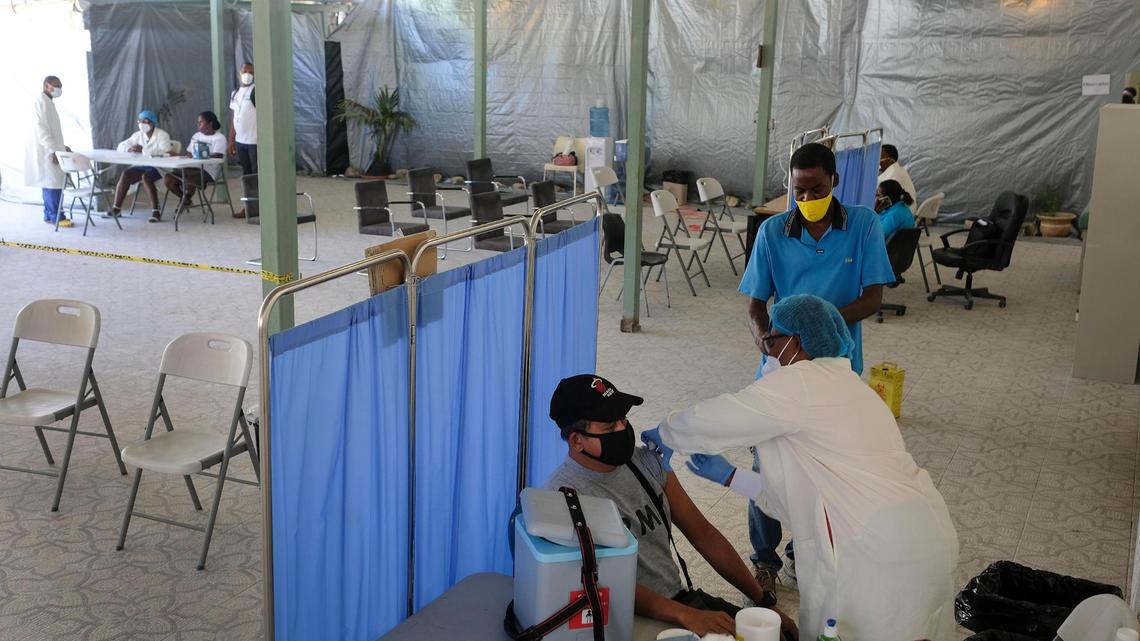 A doctor inoculates a man with his first dose of the Moderna COVID-19 vaccine at the Saint Damien Nos Petits Freres et Soeurs Hospital, in Port-au-Prince, Haiti, Saturday, July 17, 2021. Healthcare workers and senior citizens were the first people vaccinated on Friday in Haiti as part of a test run after the country recently received a shipment of doses from the United Nations.