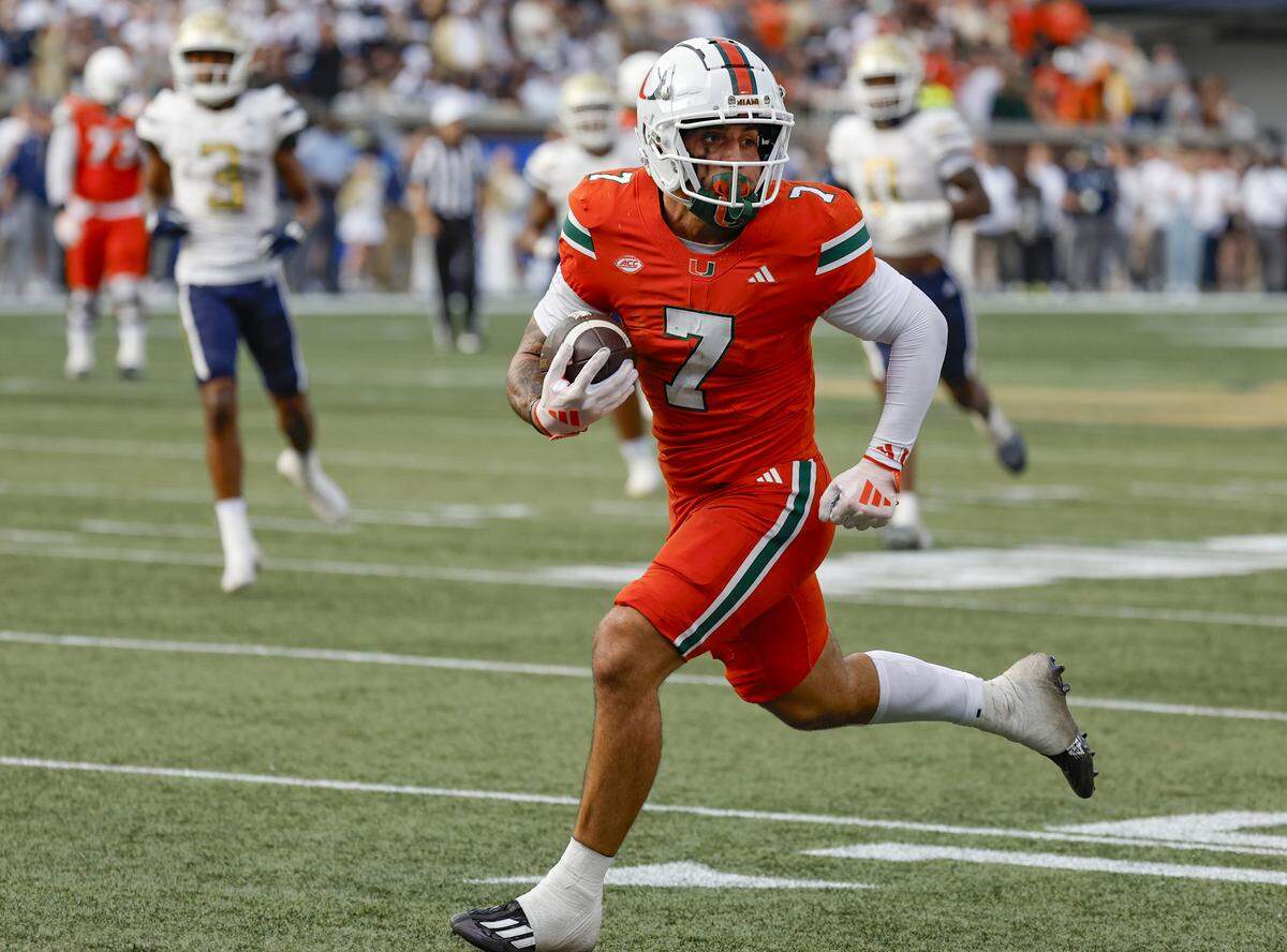 Miami Hurricanes wide receiver Xavier Restrepo (7) scores after a pass reception in the second half against the Georgia Tech Yellow Jackets during an NCAA game at Bobby Dodd Stadium at Hyundai Field in Atlanta, Georgia on Saturday, November 9, 2024.