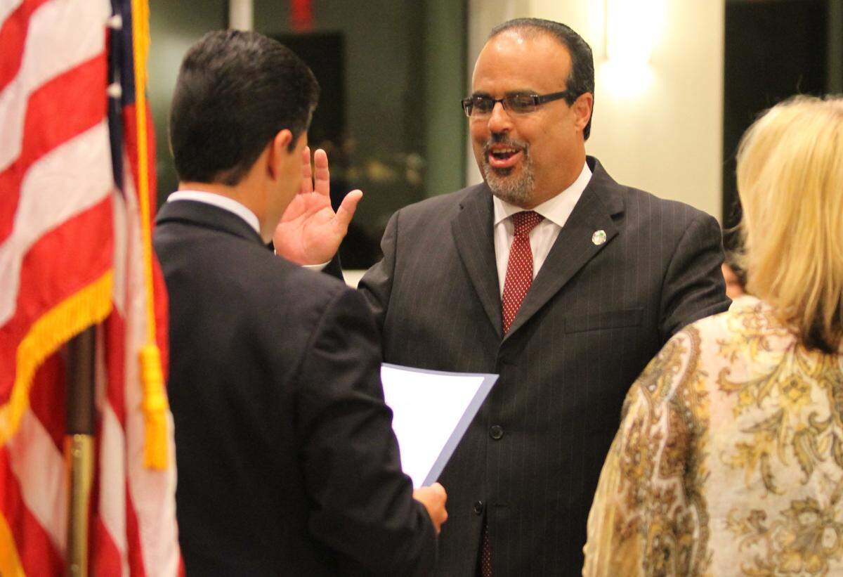 Frank Mingo is sworn in after being re-elected to a seat on the Miami Lakes council in November 2014.