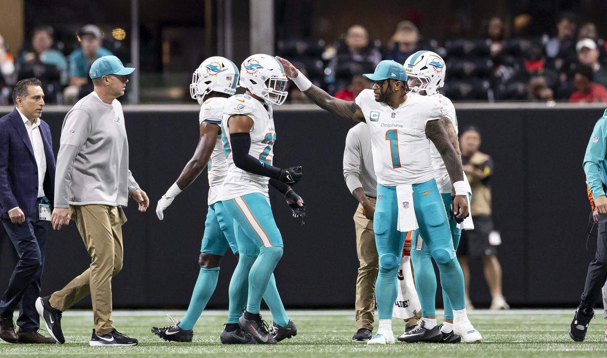 Miami Dolphins quarterback Tua Tagovailoa (1) consoles safety Minkah Fitzpatrick (29) after he sustained an injury during a play against the Atlanta Falcons in the second half of their NFL game at Mercedes-Benz Stadium on Sunday, Oct. 26, 2025, in Atlanta, Ga.
