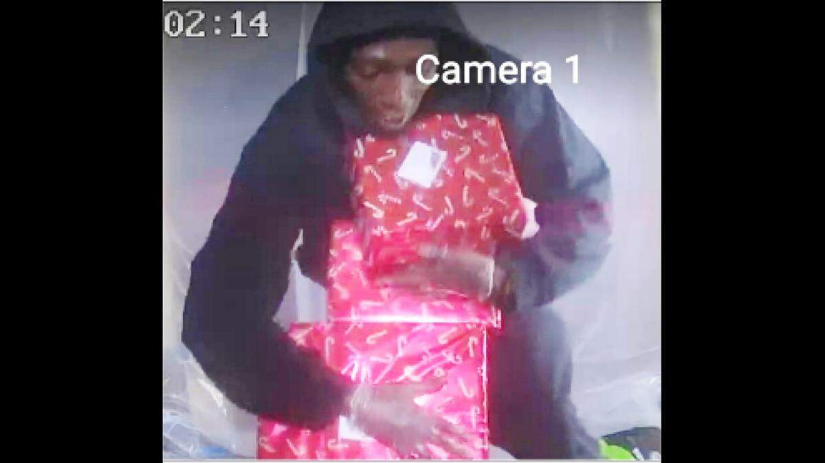 Screengrab image provided by Polk County Sheriff’s Office of a suspect stealing Christmas presents from a Lakeland home on Dec. 20, 2021.