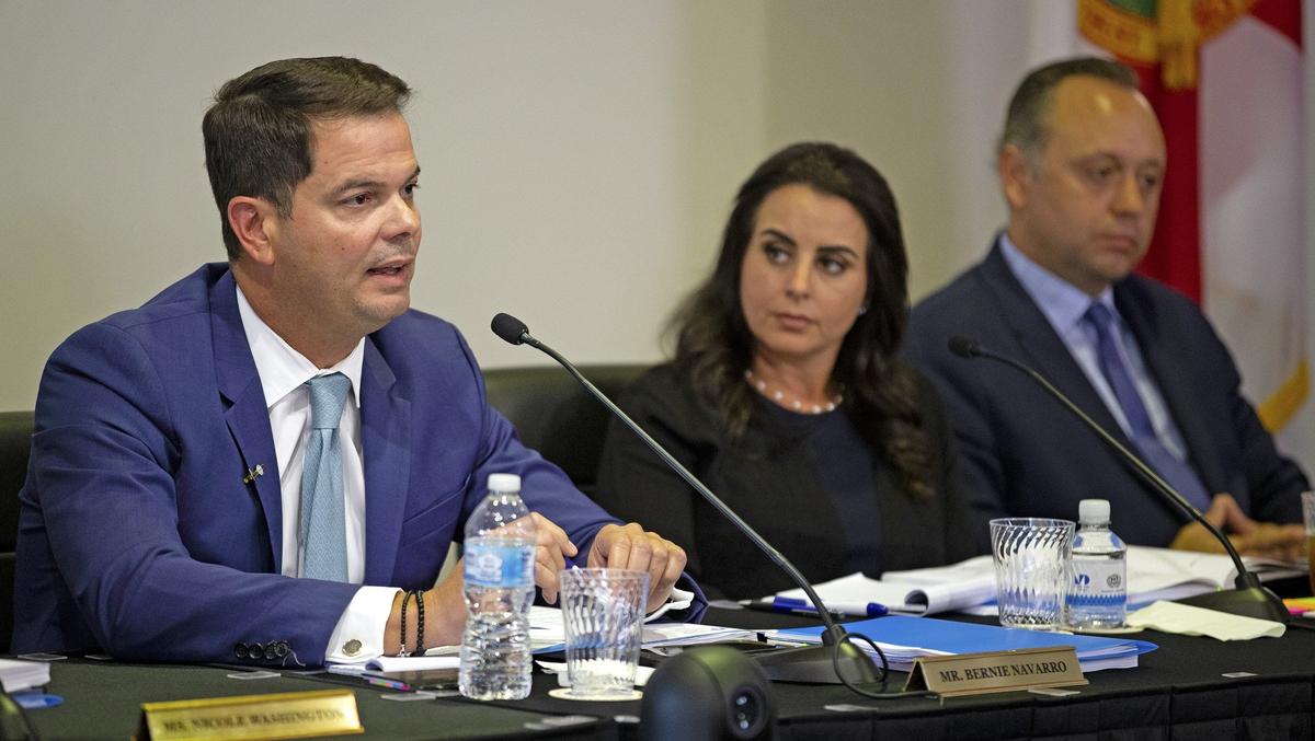 Bernie Navarro, chairman of the Board of Trustees at Miami Dade College, looks on before attempting to vote on a candidate to replace outgoing President Eduardo Padrón on July 24, 2019. To his right, board members Anay Abraham and Marcell Felipe.