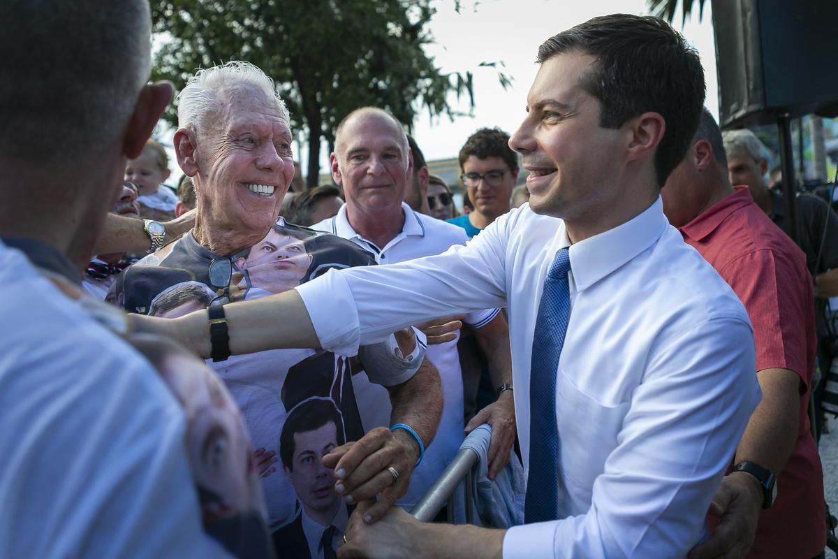 Pete Buttigieg, mayor of South Bend, Indiana, and 2020 presidential candidate, greets a voter in a crowd during a grassroots fundraiser at Wynwood Walls on Monday, May 20, 2019.