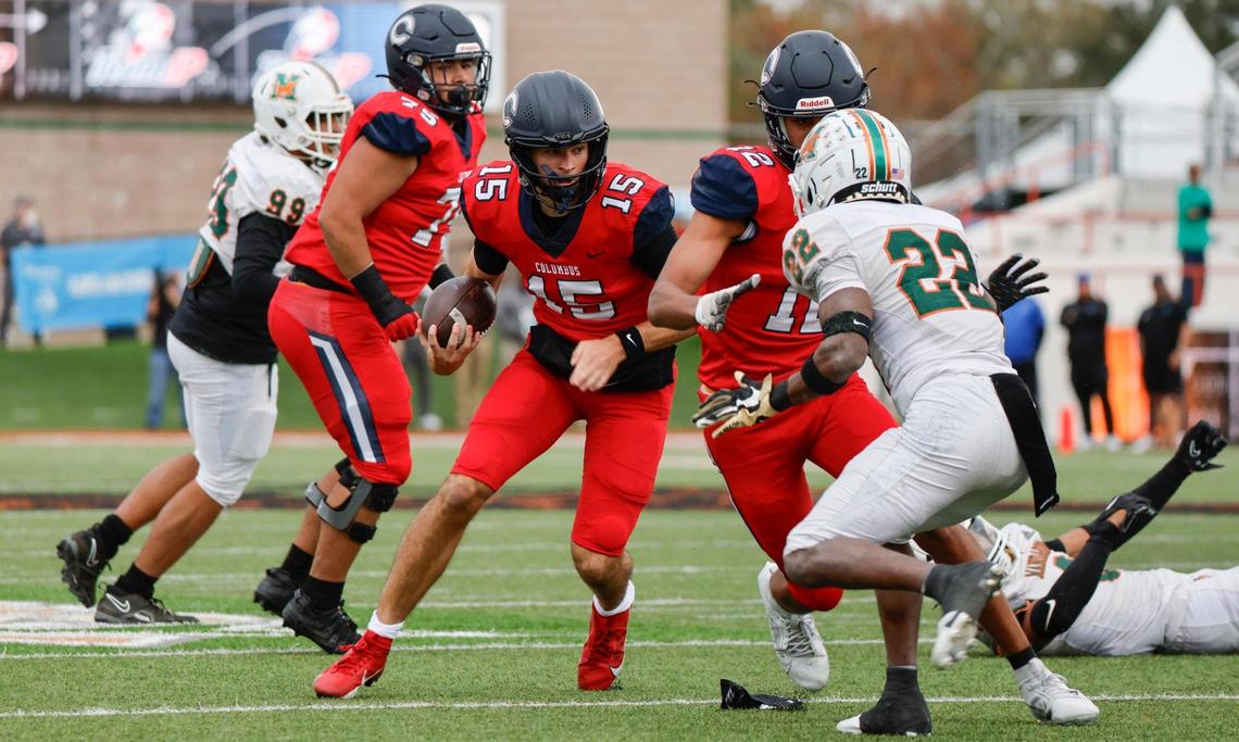 `Columbus Explorers quarterback Alberto Mendoza (15) scrambles with the ball against the Mandarin Mustangs in the first half of the game of the Class 4M state championship game at Bragg Memorial Stadium in Tallahassee, Florida, on Friday, December 8, 2023.