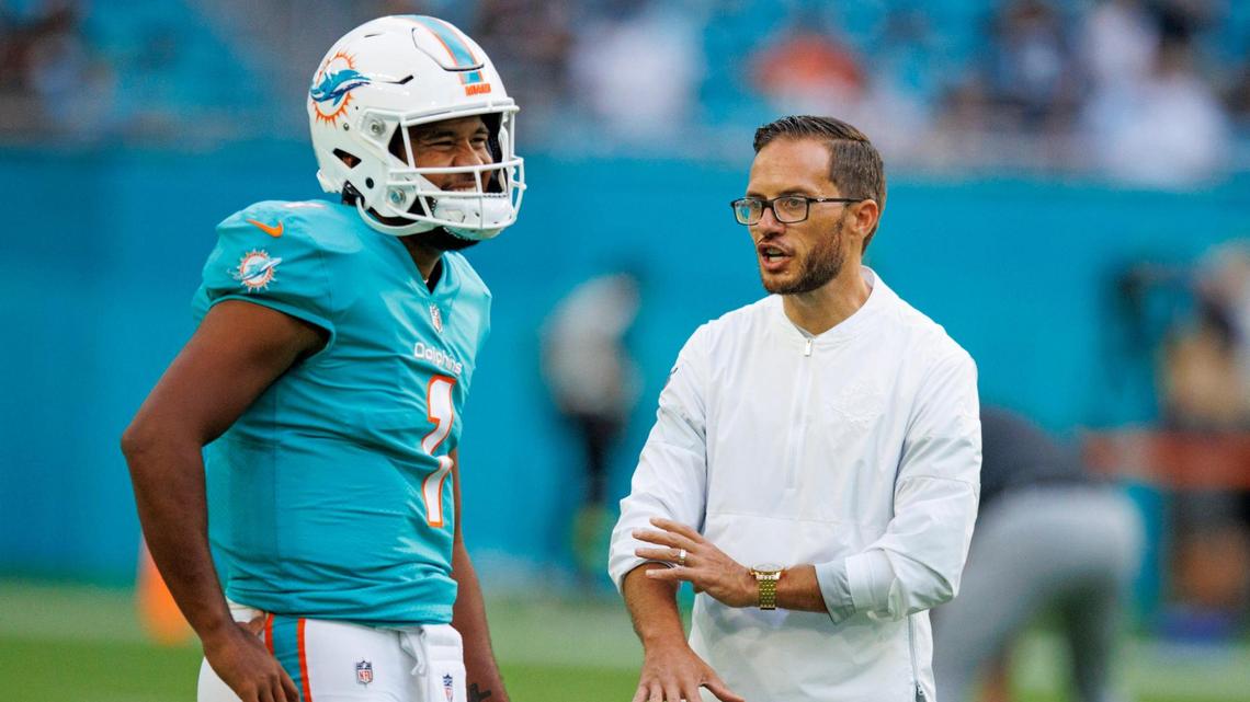 Miami Dolphins quarterback Tua Tagovailoa (1) talks with Dolphins head coach Mike McDaniel before the start of a NFL preseason football game against the Las Vegas Raiders at Hard Rock Stadium on Saturday, August 20, 2022 in Miami Gardens, Florida.
