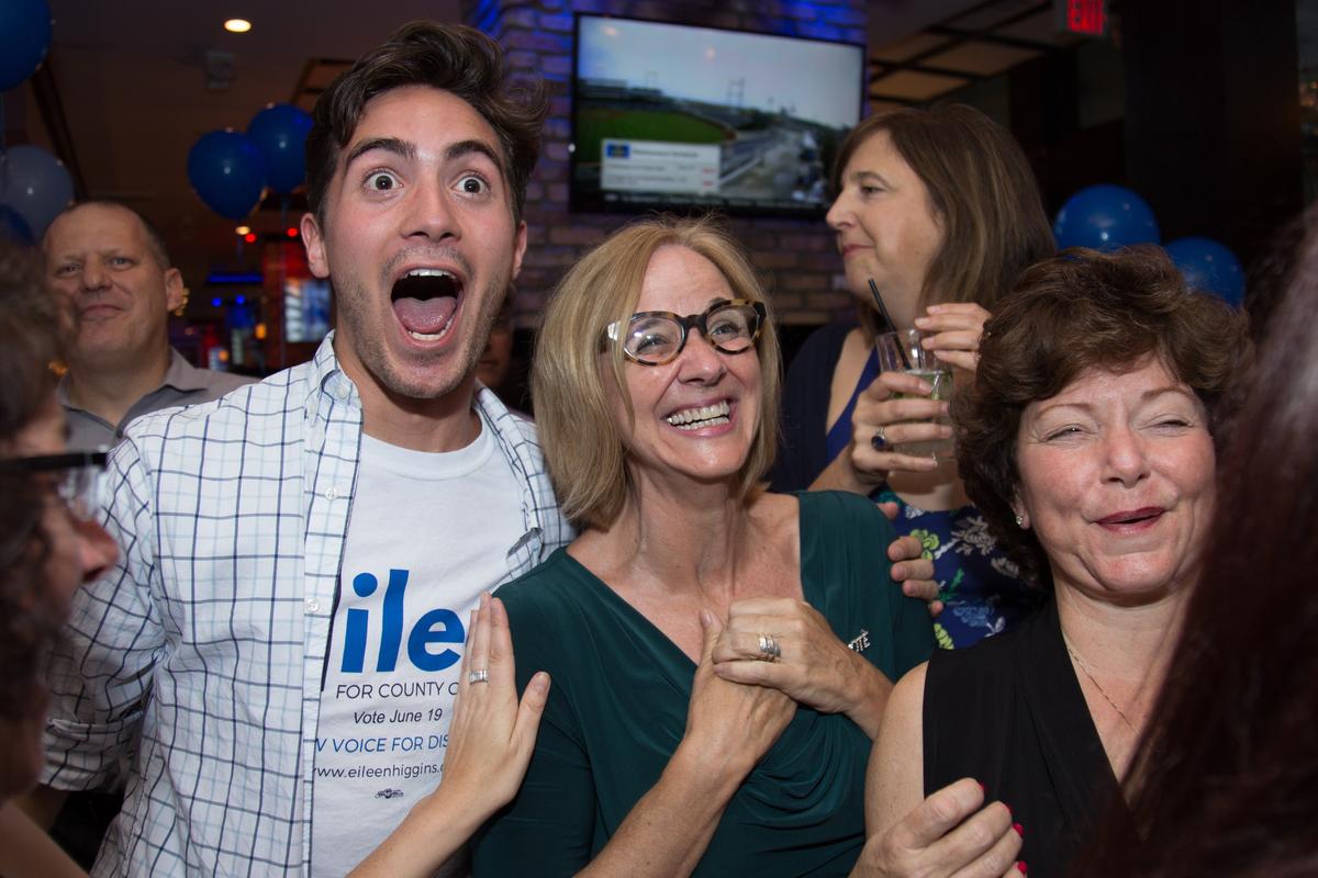 Eileen Higgins, center, candidate for vacant Miami-Dade County Commission District 5 seat, reacts with campaign communications director Guillermo Perez, left, after learning the first results of the special election during a party at American Social in Brickell on Tuesday, June 19, 2018.