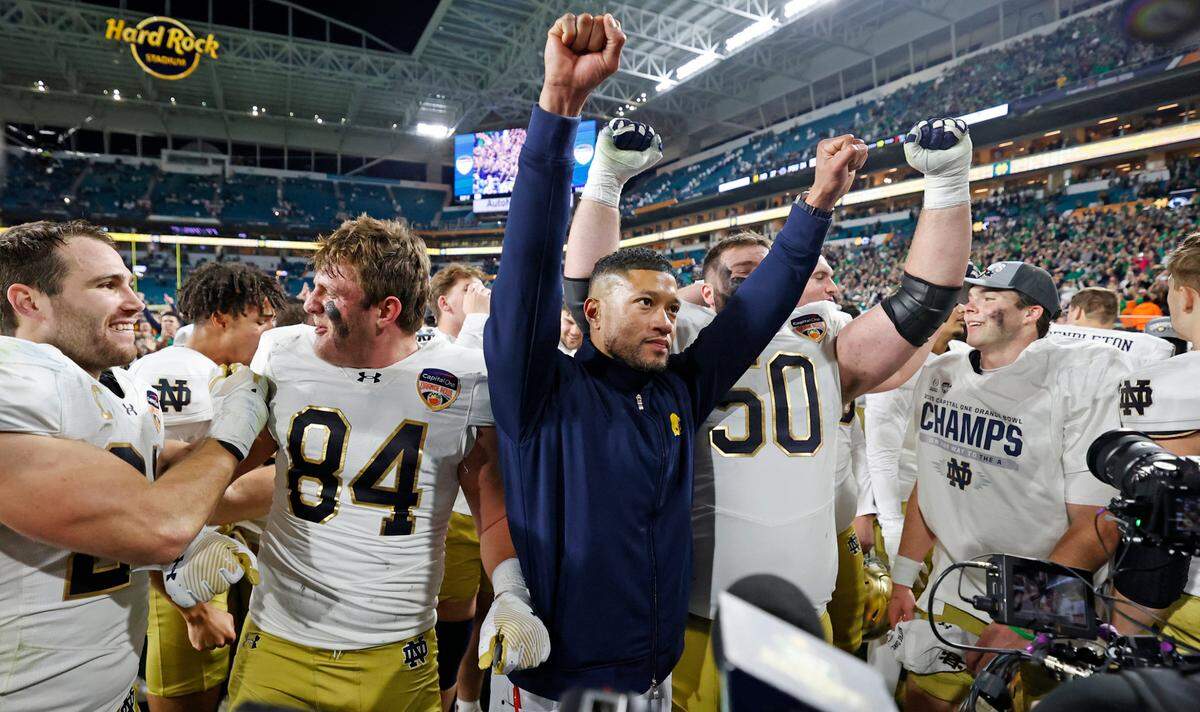 Notre Dame Fighting Irish head coach Marcus Freeman celebrates with players after defeating Penn State Nittany Lions in their NCAA Playoff Semifinal Capital One Orange Bowl football game at Hard Rock Stadium in Miami Gardens, Florida on Thursday, January 9, 2025.