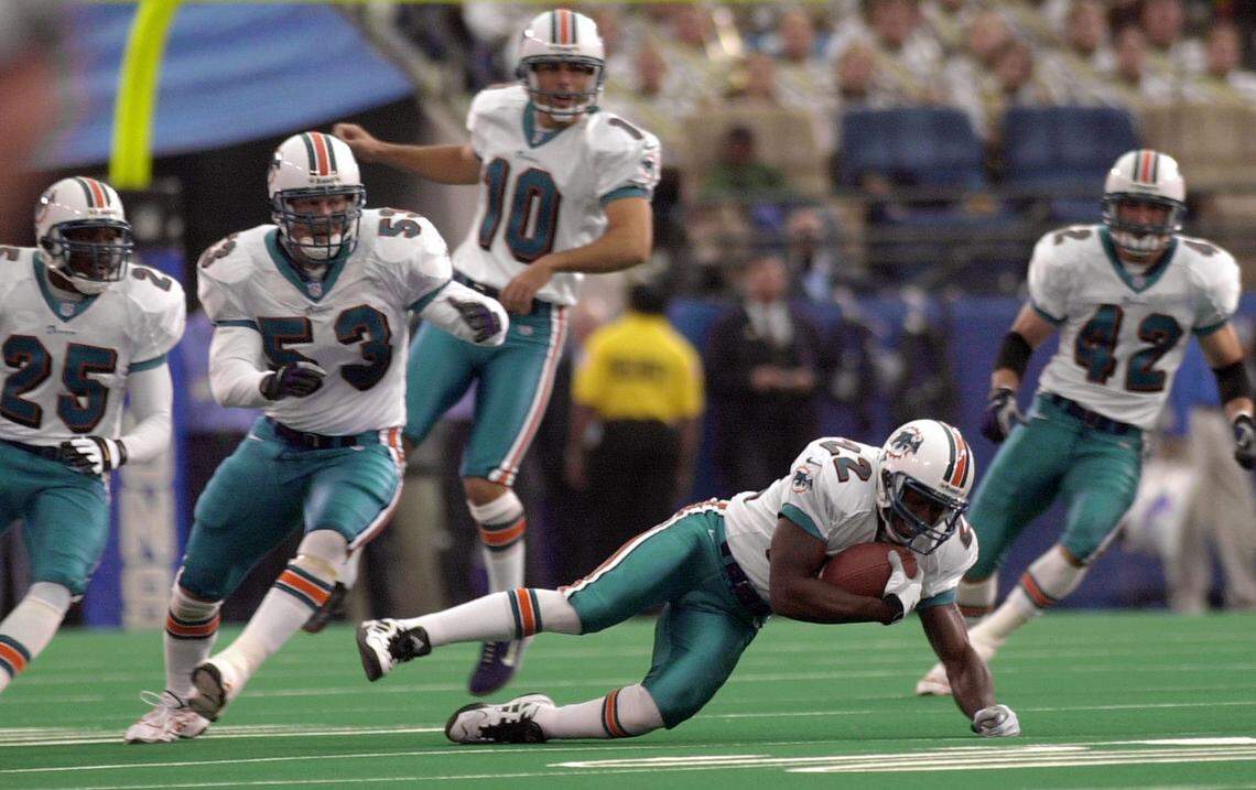 Miami Dolphins cornerback Terrance Shaw (22) recovers an onside kick as Greg Jeffries (25), Larry Izzo (53), kicker Olindo Mare, and Trent Gamble (42) look on in the first quarter against the Detroit Lions at the Pontiac Silverdome in Pontiac, Mich., Sunday, Nov. 5, 2000. (AP Photo/Paul Sancya)