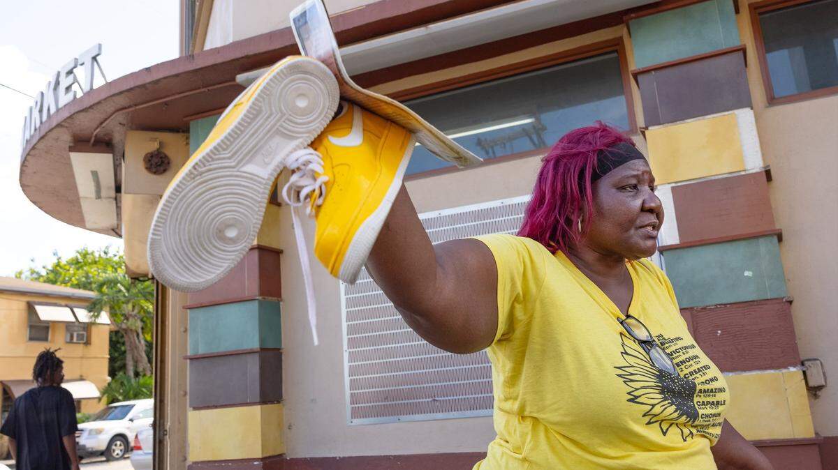 Lasonja Mills Vandyke, mother of 16-year-old Brandon Mills who was killed in a mass shooting in 2009, holds the shoes that her son had on when he was killed. Vandyke returned to the scene of the shooting in Liberty City for the first time on Aug. 27, 2024. “His father used to call him yellow,” said Vandyke.