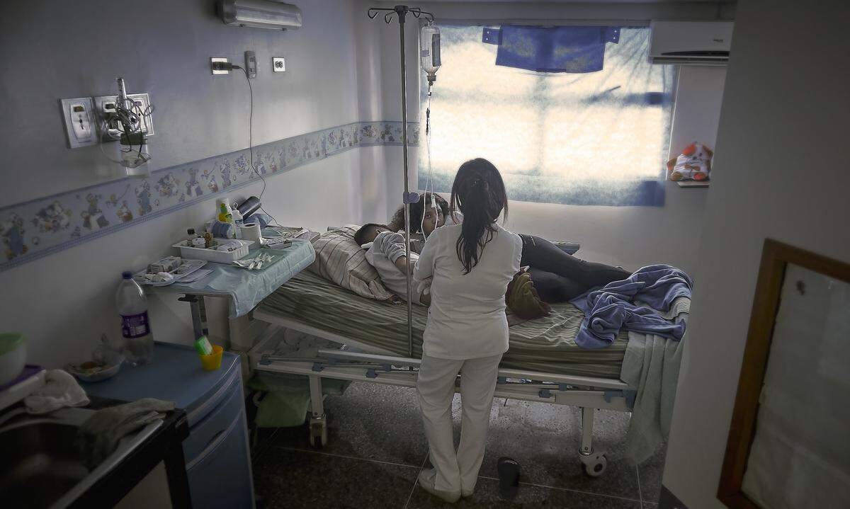 Jeandel Silva, 13, is receiving a painful medical treatment at the nephrology ward of a hospital in Caracas, Venezuela.