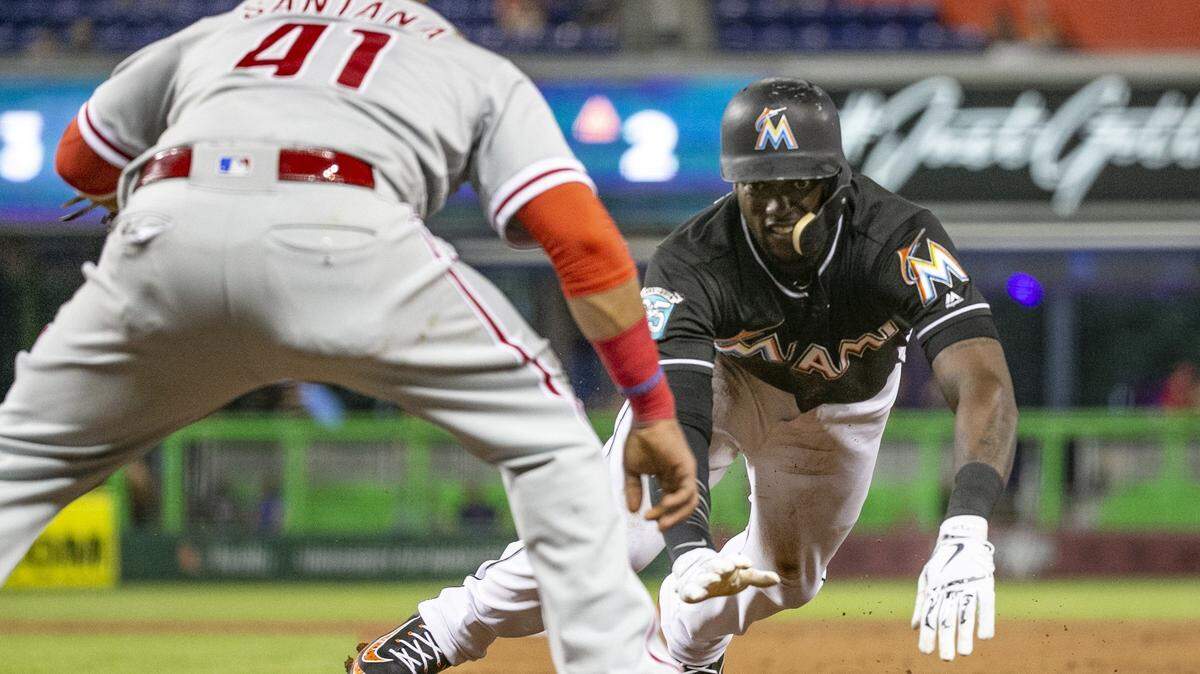 Philadelphia Phillies first baseman Carlos Santana (41) tags out Miami Marlins left fielder Cameron Maybin (1) in the third inning as the Miami Marlins host the Philadelphia Phillies at Marlins Park on Friday, July 13, 2018. 