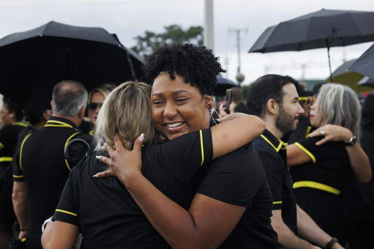 Semone Westmaas, who worked as a Spirit Airlines flight attendant for 15 years, hugs a co-worker as the employees gather across from headquarters on Monday, May 4, 2026, in Dania Beach, Fla. Spirit Airlines employees were recently left without jobs as the airlines closed Saturday. “We were a family,” said Amy Drinkhouse, MEC President of Spirit Flight Attendants Union. “It's the little guys that always lose.”