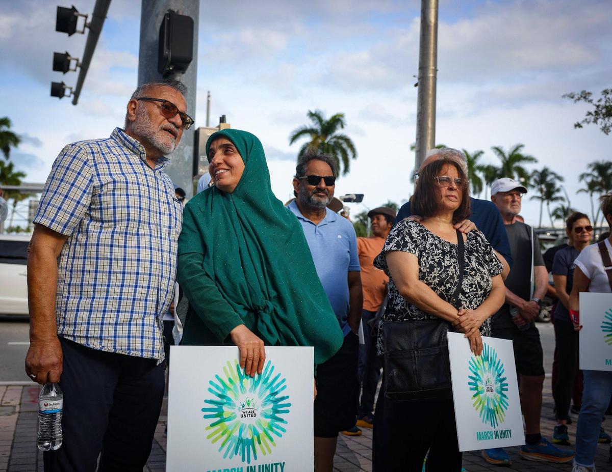 Mohammad Mortazavi, left, and his wife attend the We Are United march on Sunday, Nov. 5, 2023, at the Freedom Tower in Miami.