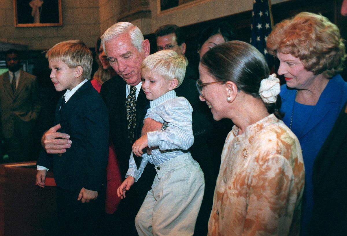 Judge James Lawrence King picks up his grandchildren, Brett Colbert, 5, left, and Ryan Colbert, 4, to pose for a photo with his wife, Mary, far right, and Supreme Court Justice Ruth Bader Ginsberg after King was honored in Miami.
