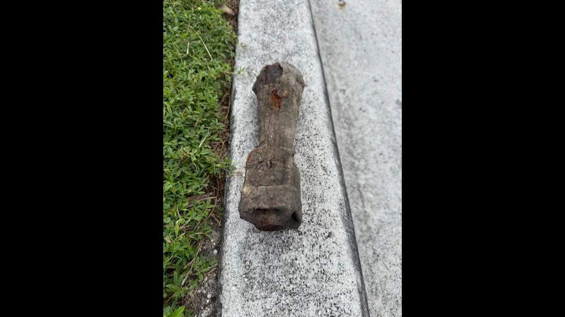 An old mortar shell is laid on the curb of a street in Key West Wednesday, Oct. 29, 2025. Construction crews dug up the piece of ordnance, prompting an evacuation of the immediate area.
