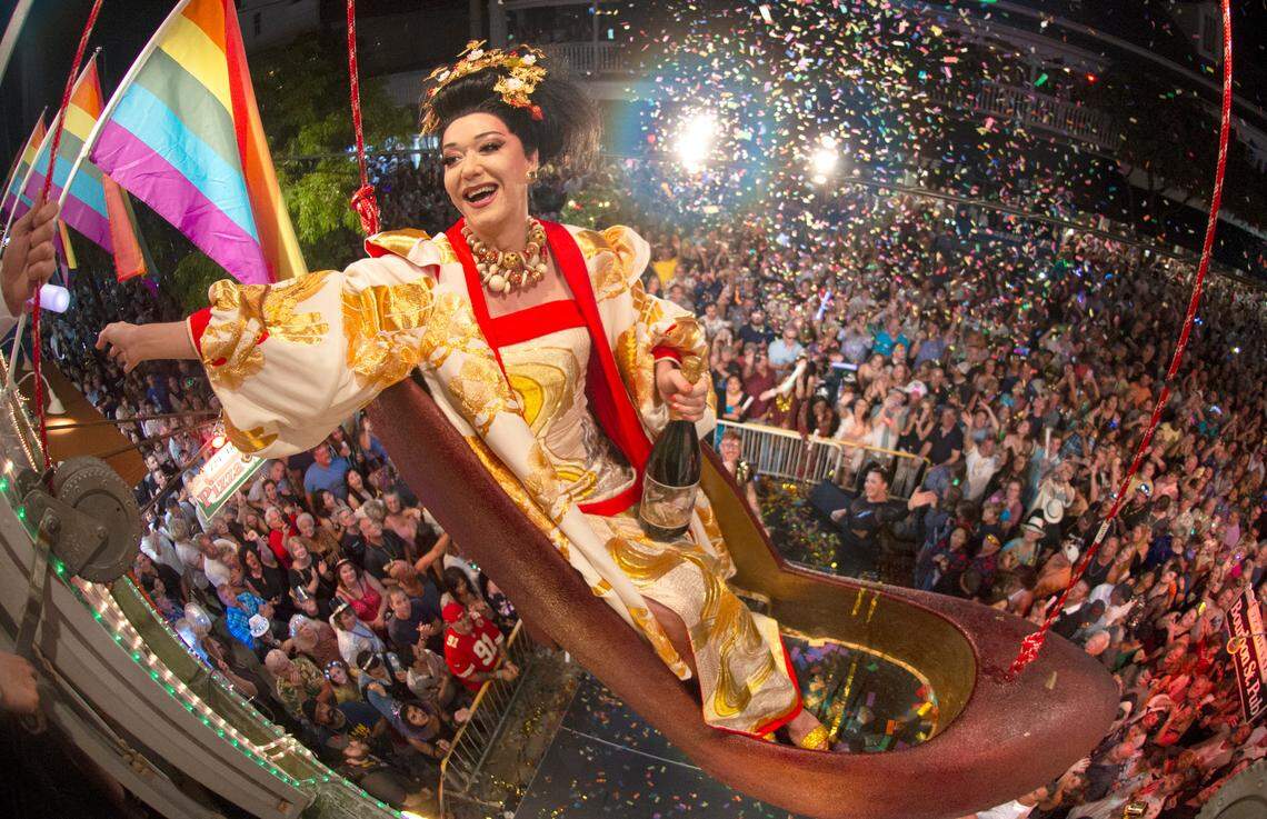 Female impersonator Gary Marion, known as “Sushi,” sits in a large replica of a women’s high heel shoe while dangling high above Duval Street in Key West on Dec. 31, 2019. The event is one of six offbeat Key West takeoffs on New York City’s Times Square ball drop.