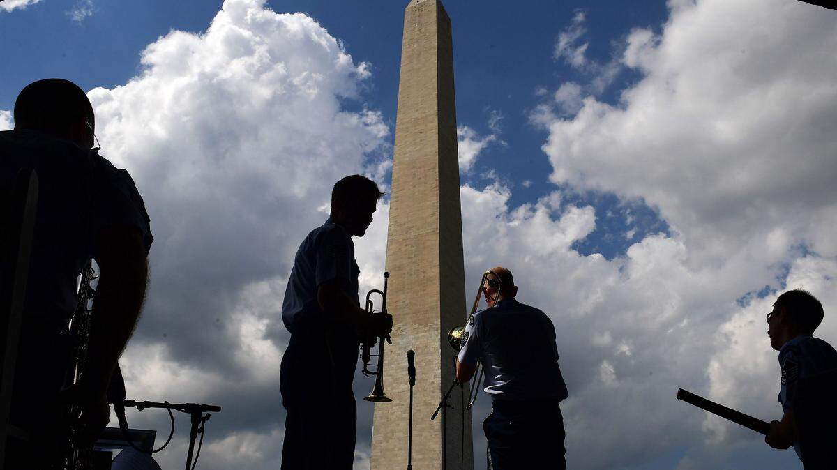 Tourists gather near the Washington Monument,