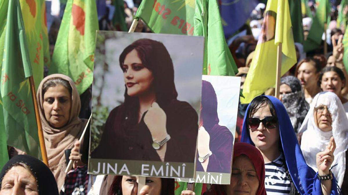 On Sept. 26, Kurdish women in the city of Qamishli, northern Syria, hold portraits of Mahsa Amini as they condemn her death in Iran.