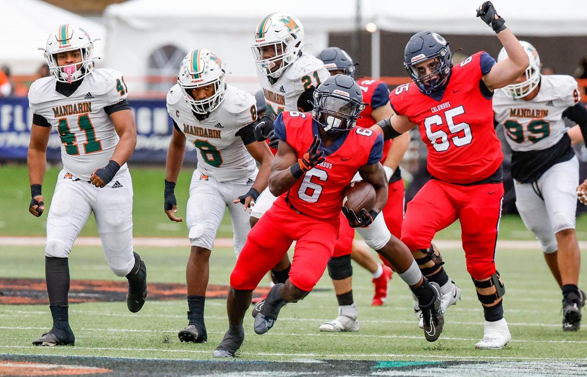 Columbus Explorers running back Edward Bandy (6) breaks open as the Mandarin Mustangs give chase in the first half of the FHSAA State Championships, Class 4M, at Bragg Memorial Stadium in Tallahassee, Florida, on Friday, December 8, 2023.