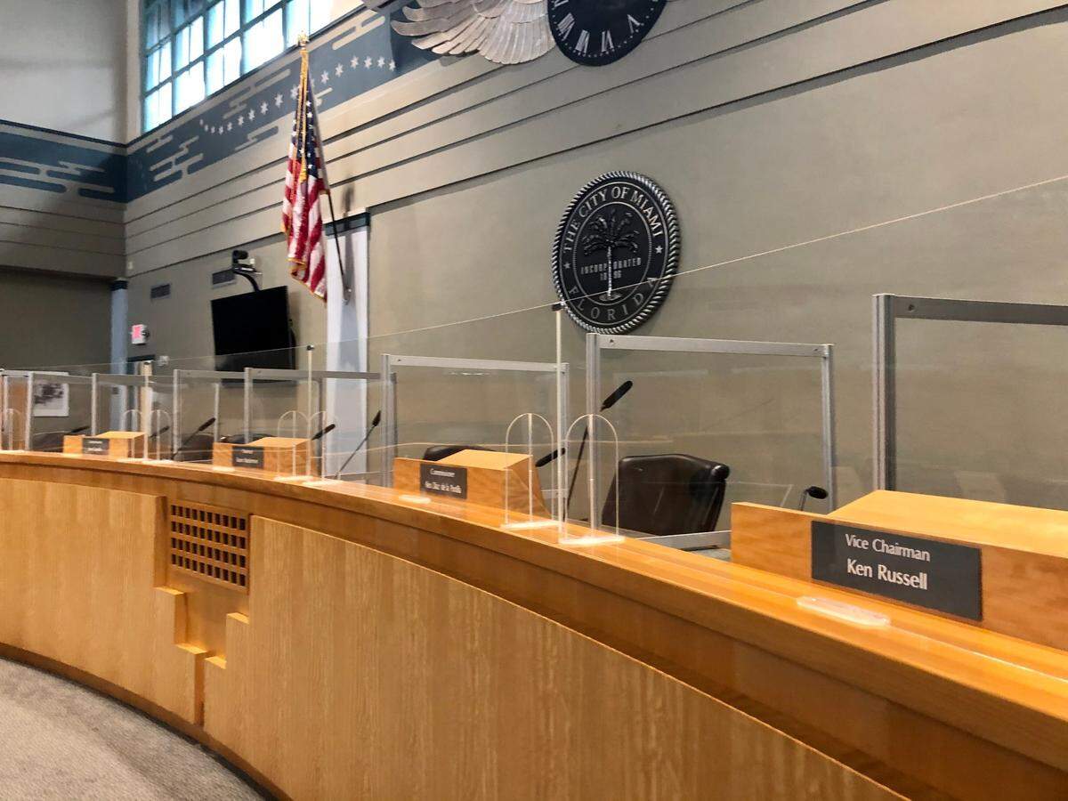 Acrylic barriers divide the seats for Miami city commissioners as local governments resume in-person meetings across Florida. They’ve been allowed throughout 2020, but Gov. Ron DeSantis in March suspended the requirement for elected officials to be in the same space to meet quorum rules for public meetings.