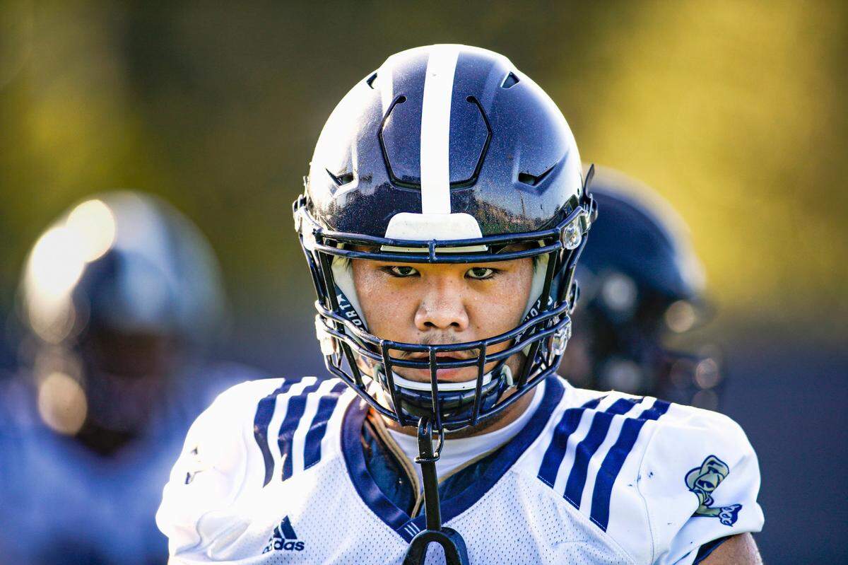 FIU center Ming Tjon (69) watches from the field during football practice at Florida International University in Miami, Florida, on Tuesday, August 16, 2022.
