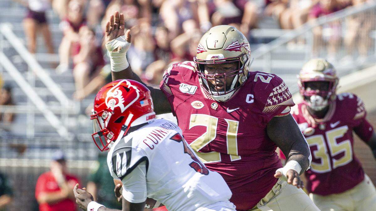 Florida State defensive tackle Marvin Wilson (21) moves in for the sack of Louisville quarterback Malik Cunningham (3) in the first half of an NCAA college football game in Tallahassee, Fla., Saturday, Sept. 21, 2019. 