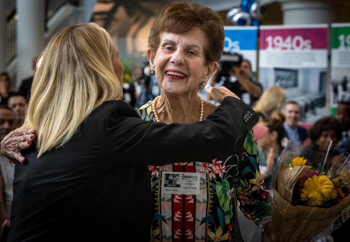 Fort Lauderdale, FL- January 4, 2023 - Newana Bowman, right, first baby born at Broward Health in 1938 gets a bouquet of flowers and a hug from Heather Havericka, CEO, Broward Medical Center, during a ceremony to celebrate the 85th Anniversary of Broward Health. The ceremony was held in the main lobby of Broward Health Medical Center, 1600 S. Andrews Avenue, Fort Lauderdale