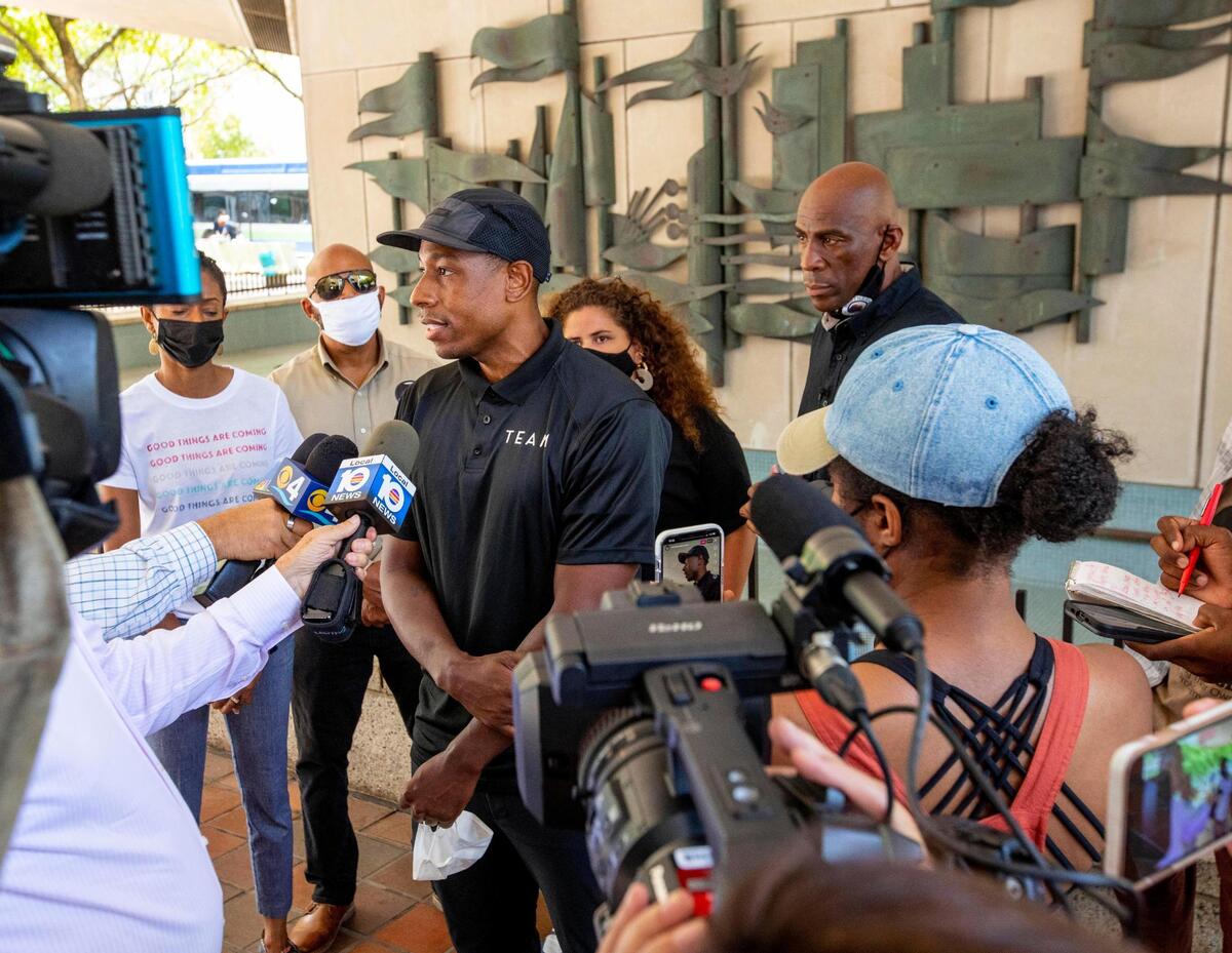 Director of Health Programs for Dream Defenders, Dr. Armen Henderson, speaks to the media along with other grassroots organizations pressuring Miami-Dade officials to fund their initiatives aimed at reducing gun violence, outside the Stephen P. Clark Government Center in Downtown Miami on Friday, June 4, 2021.