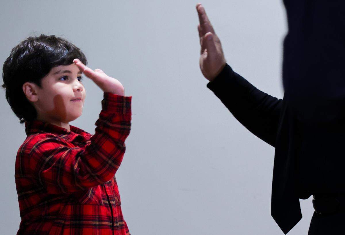 Aiden Pupo, one of nine students being honored, gives a high-five as he accepts tickets to the Rapids Waterpark at a ceromony held by the The Right Thing Program and Miami Police inside the auditorium of the Chief Clarence Dickson Police College on Wednesday, January 21, 2026, in Miami, Florida. 