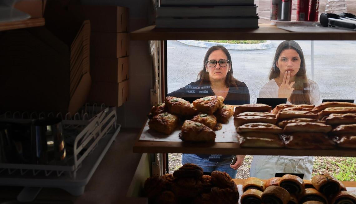 Customers take a moment to survey Ophelia’s pastries, which include cinnamon rolls, chocolate chunk or sesame guava cookies and banana walnut bread as well as savory options.