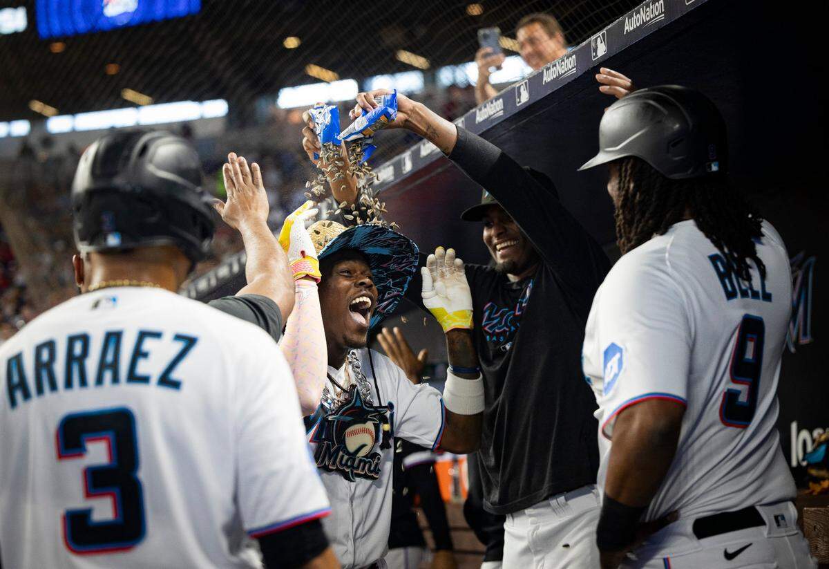 Miami Marlins center fielder Jazz Chisholm Jr. (2) is congratulated by teammates after hitting a grand slam during the third inning of a baseball game against the Atlanta Braves on Sunday, Sept. 17, 2023, at loanDepot Park in Miami, Fla.