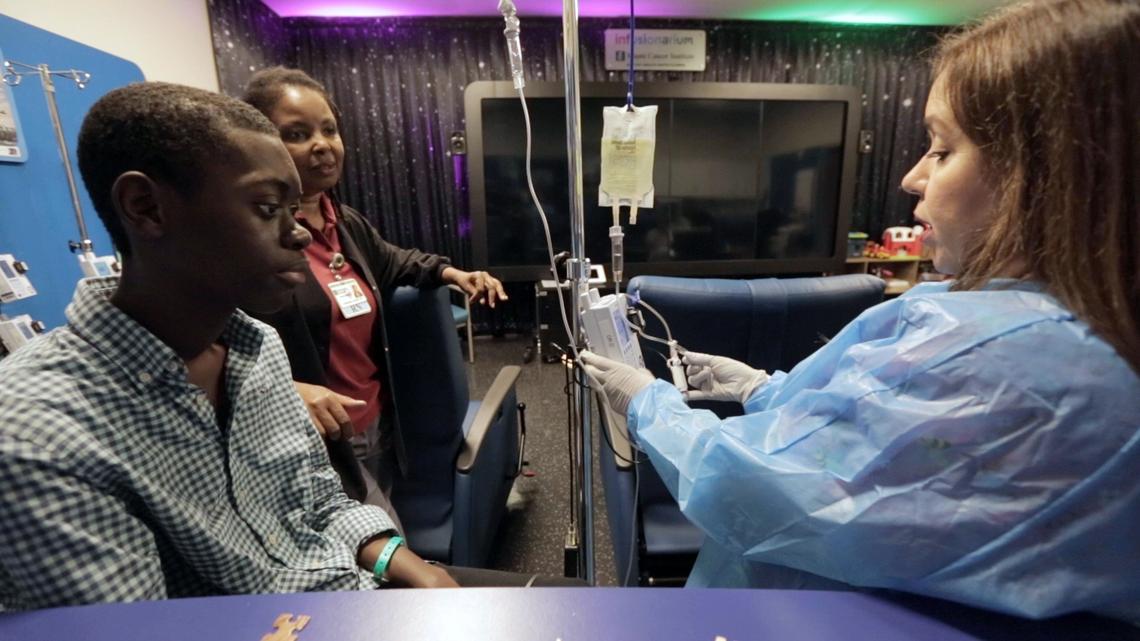 Baptist Health nurse Sahidy Aguilar tends to Djonsly Alcin, 14, as he receives chemotherapy. Baptist Health South Florida is taking care of Djonsly’s medical expenses while he’s here in the U.S. receiving treatment for a rare brain tumor.