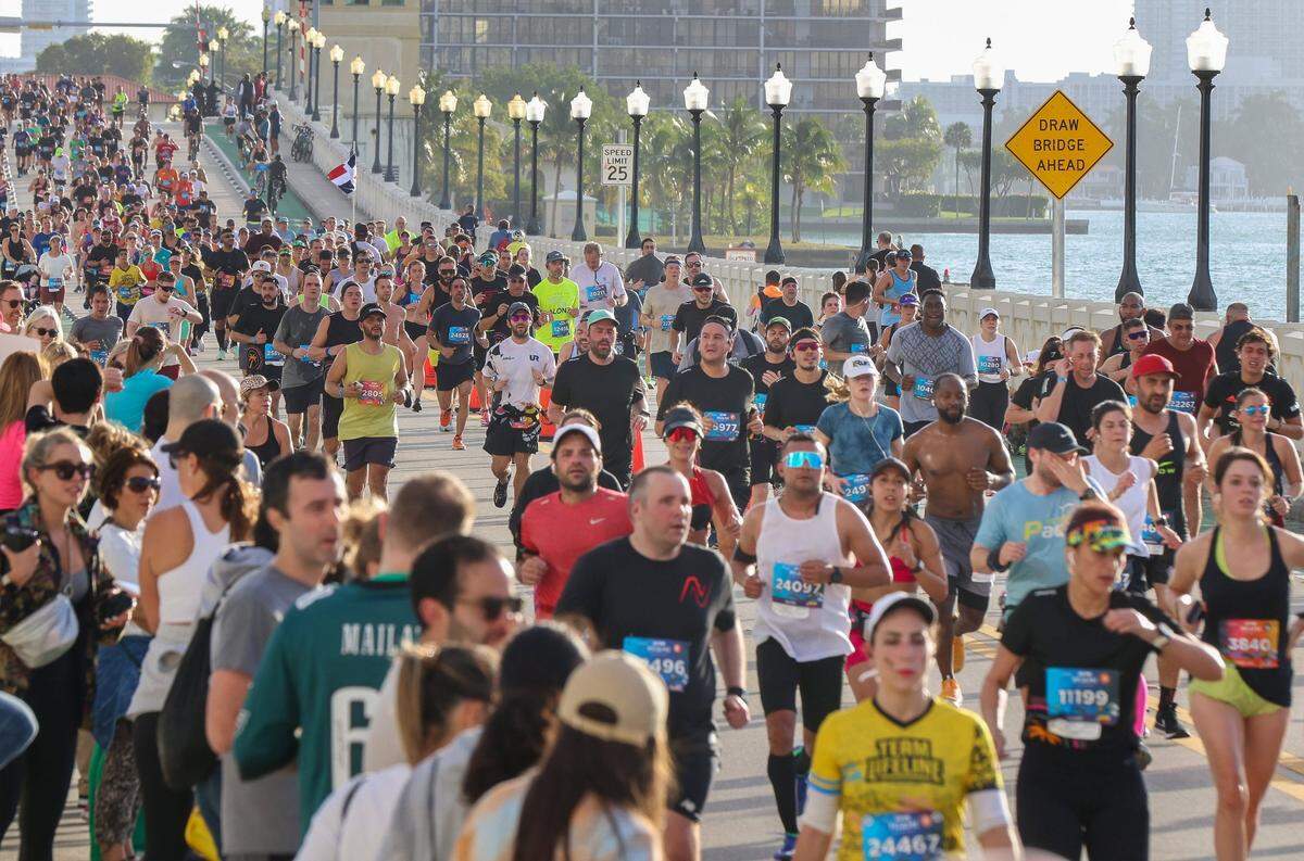 Some of the 12,000 runners in the Life Time Miami Marathon and Half Marathon make their way westbound on the Venetian Causeway toward Miami on Sunday, Jan. 29, 2023.