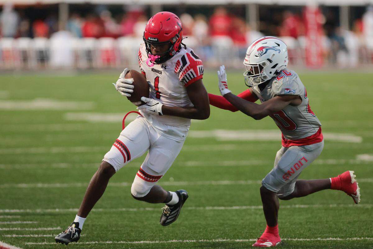 Monarch Knights athlete Jabari Brady (1) is pushed out of bounds by Chaminade-Madonna Lions defensive back Sam Brown (20) after a carry during the first quarter of a high school football game at Chaminade-Madonna College Preparatory school in Hollywood, Florida, Friday, October 3, 2025.