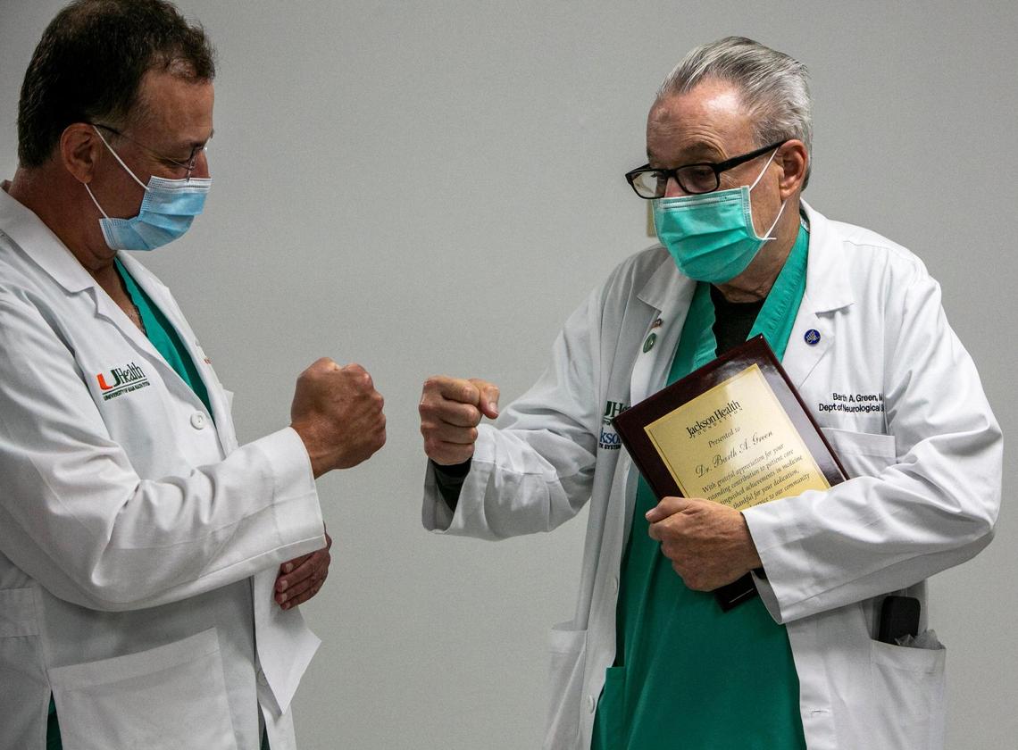 Dr. Barth Green, right, fist bumps Dr. Allan D. Levi, M.D., Ph.D., Chairman, Dept. of Neurological Surgery, University of Miami Miller School of Medicine (left) after a small speech honoring Dr. Green at the surgeon’s lounge at Jackson Memorial Hospital, where Green has worked for more than 40 years. Friday, Green – world-renowned neurosurgeon and humanitarian – performed his last surgery at Jackson. Green, professor and former chairman of the Department of Neurological Surgery at the University of Miami Miller School of Medicine, has treated thousands of patients suffering from spinal cord injuries through the Miami Project to Cure Paralysis, which he co-founded.