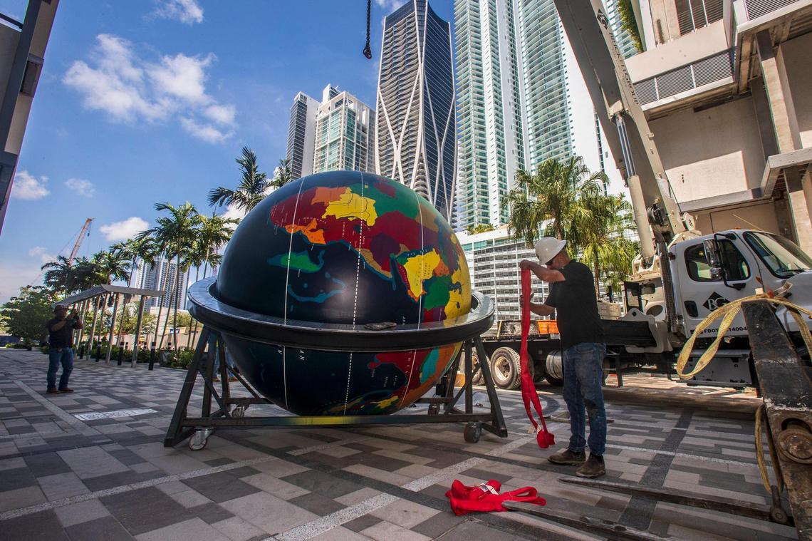 Carl Burzenski with the Brickell Group gets the rigging ready Wednesday, July 13, 2022 to install the Pan Am globe, which used to be at the Miami science museum for 55 years, at its new location in the World Paseo and World Promenade at the Miami Worldcenter development downtown.
