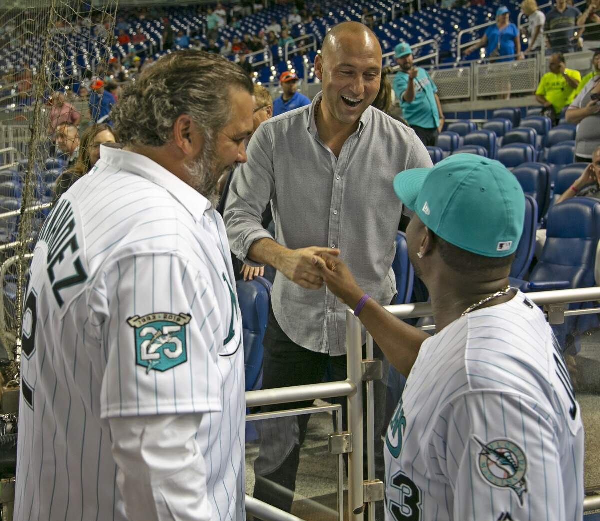 Former Marlins Alex Fernandez and Charlie Johnson greet Marlins CEO, Derek Jeter as the Miami Marlins prepare to host the San Diego Padres at Marlins Park on Saturday, June 9, 2018. 