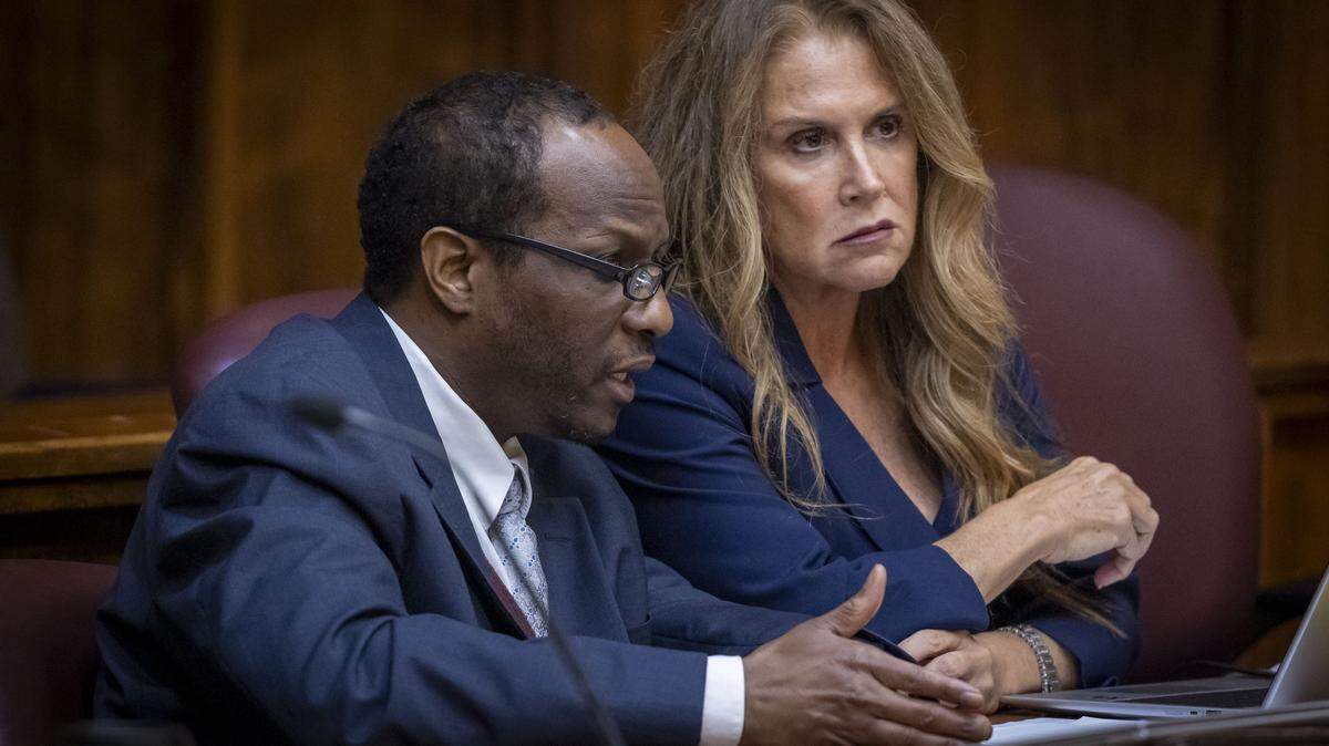 Miami, FL, November 5, 2025 - Labrant Dennis, left, talks to a member of his defense team during closing arguments  in his death penalty resentencing trial. Dennis was convicted in 1998 of killing Timwanika Lumpkins, his ex-girlfriend, and UM linebacker Marlin Barnes. On Thursday, Nov. 6, 2025, jurors voted to sentence him to life in prison rather than send him back to Death Row.