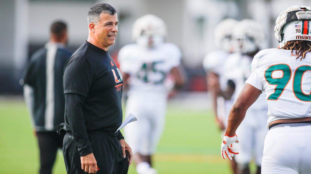 Miami Hurricanes head coach Mario Cristobal watches from the field during football practice at the University of Miami campus in Coral Gables, Florida, Tuesday, August 30, 2022.