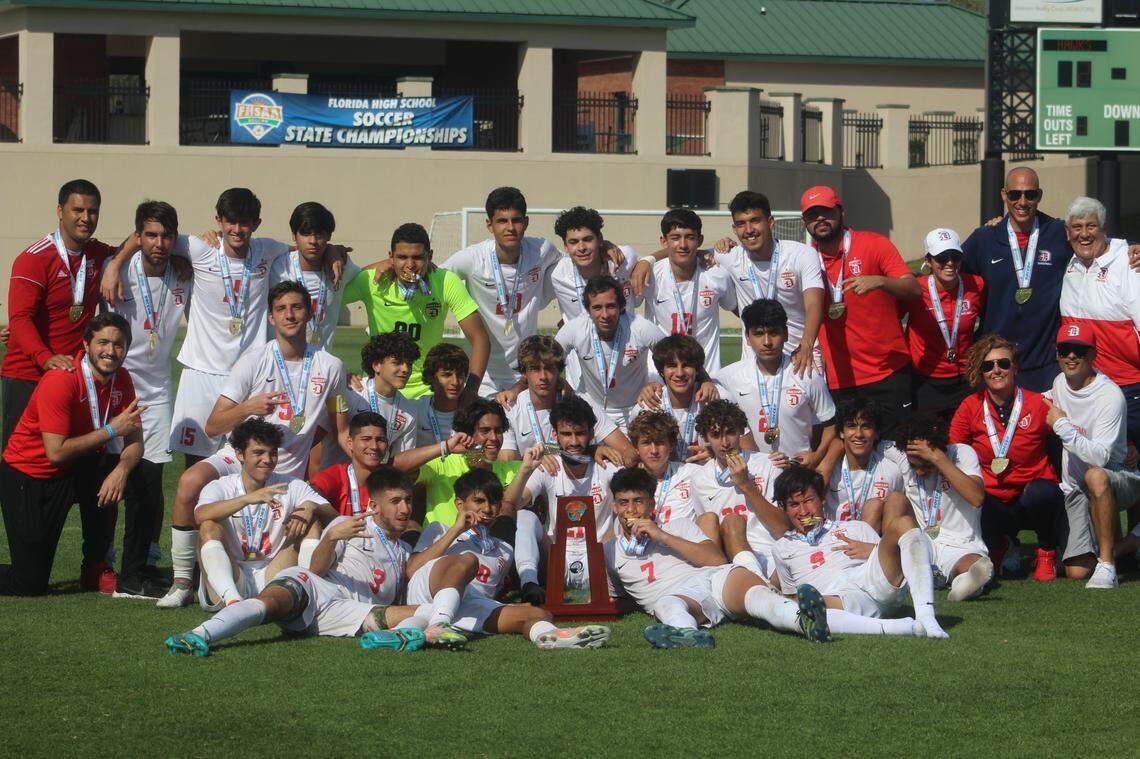 Doral Academy’s boys’ soccer team celebrates after beating Viera 3-2 in the Class 6A state championship match on Friday at Spec Martin Stadium in DeLand. The Firebirds won their second state title in a row.